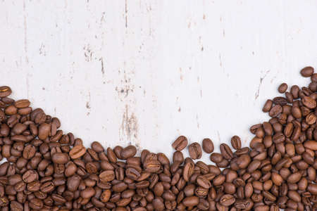 Coffee beans on a white textured background, empty copy spaceの写真素材