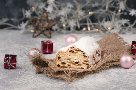 Christstollen, traditonal christmas cake with nuts, raisons, marzipan on a blue background, empty space for textの写真素材