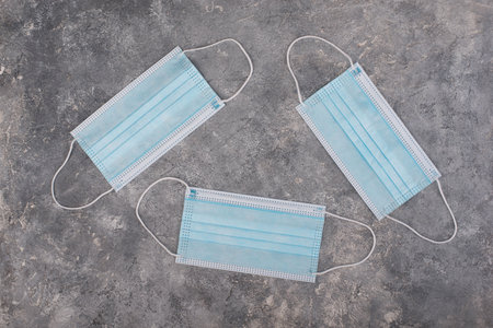 Medical masks to protect from worldwide pandemic in 2020 and 2021, blue colored, empty copy space...