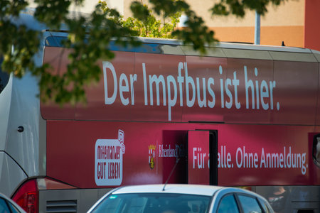 Vaccination bus in Trier, free covid 19 vaccination in front of a super market, Germany, healthcare programのeditorial素材