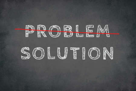 The words problem and solution are standing on a chalkboardの写真素材