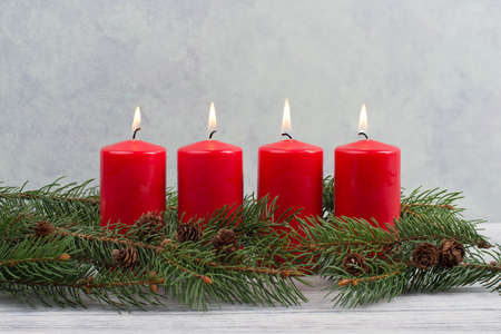 Red candles on a advent wreath, christmas decoration with candlelightの写真素材