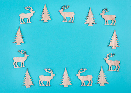 Reindeers, christmas trees, blue colored background, copy space for text, greeting card, winter backdropの写真素材