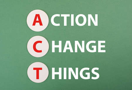 The words act, action, change, things are standing on a green colored background, business concept, achieving new goalsの写真素材