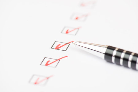 Red colored checkmarks in little black boxes, white paper, education, test, to dol ist, busniss...