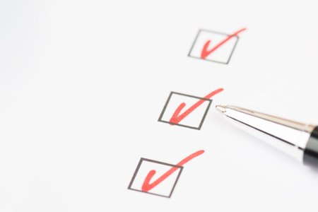 Red colored checkmarks in little black boxes, white paper, education, test, to do list, busniss...