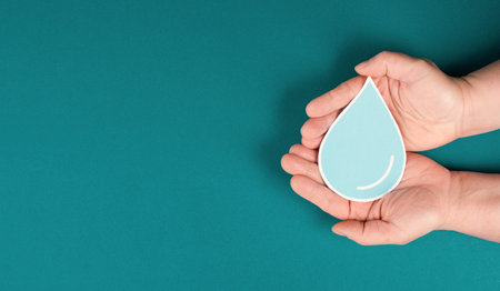 Hands holding a drop of water, paper cut out, environmental issue, copy space for text