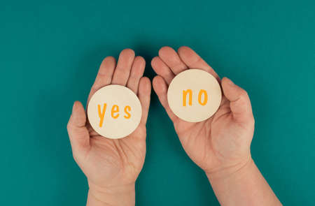 The words yes and no are standing on round signs, communication symbol, making a decision, business concept, minimalismの写真素材