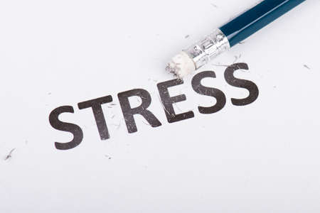 The word stress is standing on a paper, pen with eraser, burnout conceptの写真素材