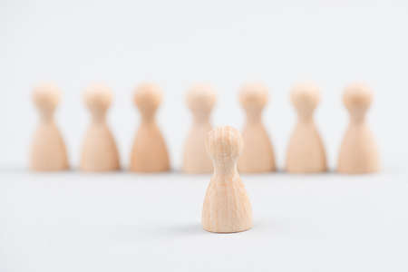 Group of people standing together, one leader standing in front of them, leadership concept, recruiting workers, education and businessの写真素材