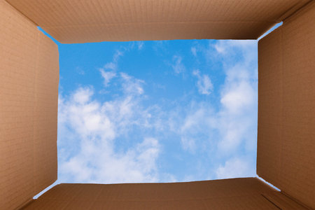 Think outside the box, open package against the blue sky, furistic vision, brainstorm for new ideas