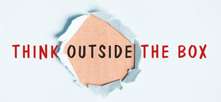Think outside the box is standing on pieces of paper, brainstorming for new ideas, being innovative,...