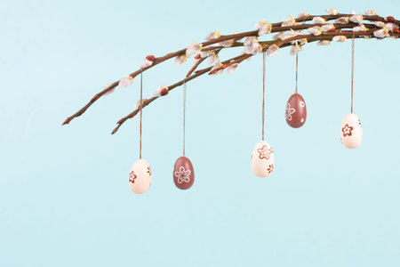 Easter holiday background, small eggs hanging on pussy willow branches, greeting card, spring...