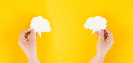 Holding a white cloud in the hand, empty copy space for text, yellow background, communication and...