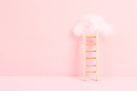 Ladder with a cloud on top, pink rose colored background, copy space, dreaming of success, creative...