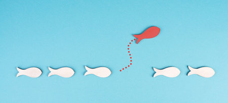 One red fish takes a different direction, leader of the group, leadership and teamwork concept, be a...