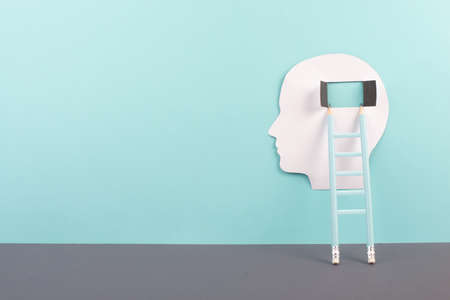 Silhouette of a man, window to the brain, ladder of success, open minded, brainstorming for ideas, disorder and psychology conceptの写真素材