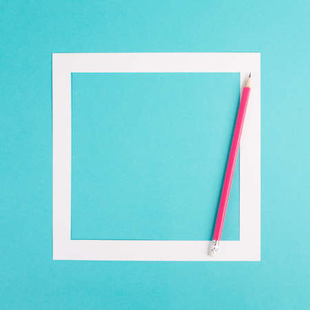 Pencils on a blue paper background, white frame with copy space for text, minimalism, creative and business concept, pastel coloredの写真素材