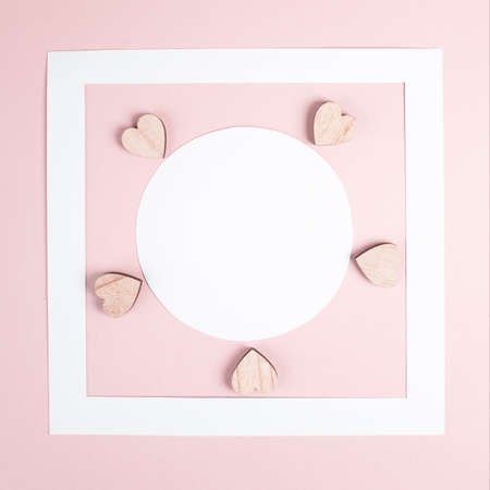 Pastel colored greeting card, white circle with copy space for text and hearts, valentines day, mothers day background, romantic layout, love conceptの写真素材