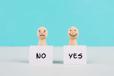 Men holding signs with the words yes and no, communication between people, business and education concept, minimalism, asking questions, looking for an answerの写真素材