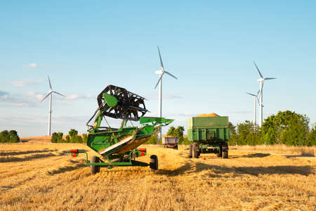 Harvester in a field of cultivated barley in Germany, harvest in the summer, agriculture for food, farmland on the countrysideの写真素材