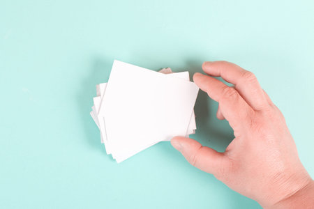 Holding a blank business card in the hand, copy space for text, marketing and advertising concept