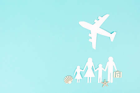 Family is going on vacation with an airplane, taking a flight for a summer holiday, greeting card, paper cut outの写真素材
