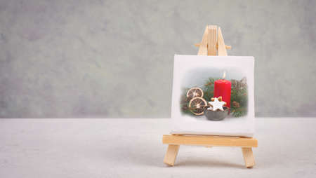 Advent wreath, christmas decoration with red candle light, drawing on an easel, copy space for text, holiday greeting cardの写真素材