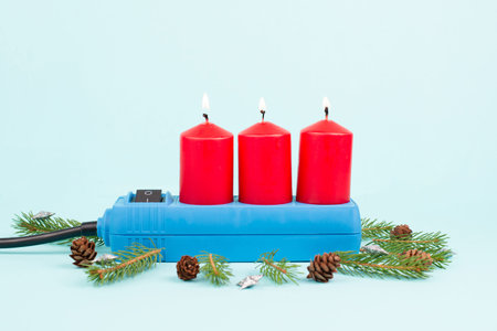 Red christmas candles in a socket, expensive electricity costs, blackout risk in Germany, cold...