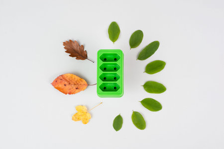 Green electricity socket with leaves, sustainable renewable energy, csr concept, environment...