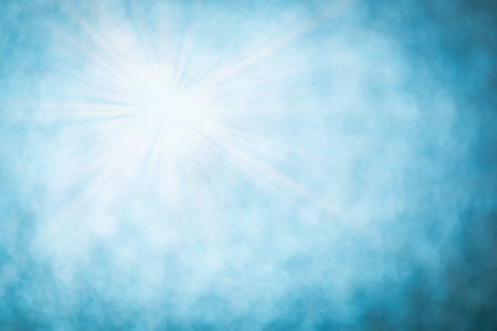 Blue bokeh background with defocused round lights and sunbeams, flare overlayの写真素材