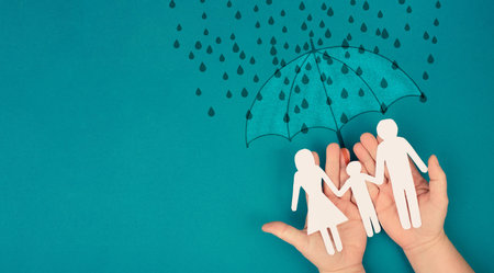 Umbrella protects family from difficult problems, help and support, social issue, insurance businessの写真素材