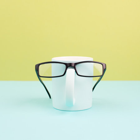 Cup or mug of coffee wearing eyeglasses, funny face, hot drink for breakfast, fathers dayの写真素材