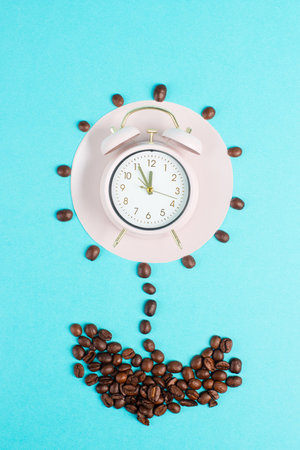 Alarm clock, flower from roasted coffee beans, wake up and have energy from caffeine, time for a breakの写真素材
