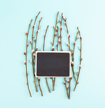 Willow branches with a chalkboard easter holiday greeting card, spring season backgroundの写真素材