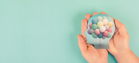 Hands holding head, brain with colorful balloons, self care, freedom and mental health concept, positive thinking, creative mind, generative AI used for balloonsの素材