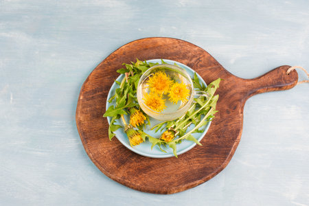 Dandelion wildflower tea, glass with herbal hot drink, alternative medicine for detox, leaves and flowersの写真素材