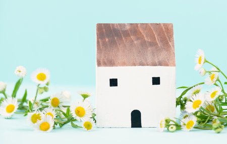House with flowers, buying or renting a home in nature, real estate concept, investment in property, sustainable lifestyleの写真素材
