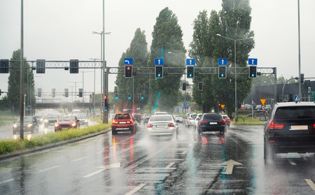Cars driving on the road, heavy rain, low visibility, slippery street, dangerous storm, overcast...