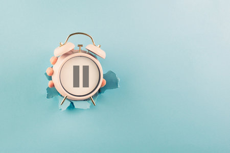 Alarm clock with pause sign, take a break, menopause concept, hormone replacement therapyの写真素材