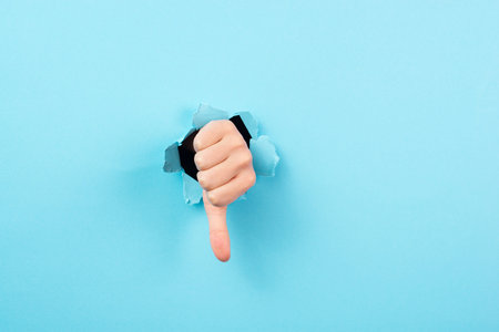 Thumb down, negative hand gesture, dislike or disagree, expression of disappointment, blue torn...