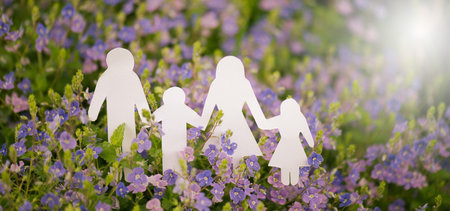 Parents with children walking on a meadow and holding hands, relationship in family, care and security concept, charity and insuranceの写真素材