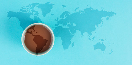 Cup of espresso with world map, international coffee day, hot caffeine drink for breakfast, take a breakの写真素材