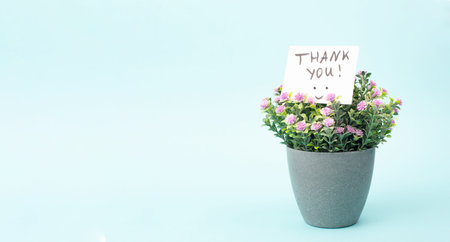 Thank you card with flowers and a happy smiling face, being grateful, support, help and charity...