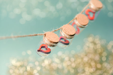 Jar with red valentine hearts, love and emotion concept, help and charity, gift, bokeh lightsの写真素材