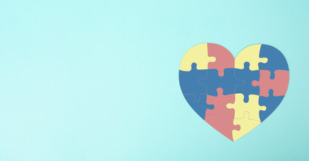 ASD autism spectrum disorder, deficits in social communication and interaction, heart with colorful jigsaw or puzzle piecesの写真素材