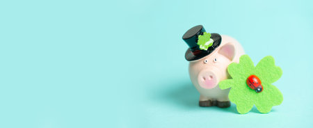 Lucky pig with shamrock, celebrate happy new year, bokeh lights, good luck wishes, background, greeting card or bannerの写真素材