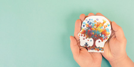 A colorful tree illustration within a head silhouette shape, suggesting concepts of mind, learning and cognitive developmentの写真素材