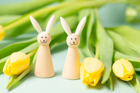 Easter bunny or rabbit smiling, happy face, yellow tulip flowers, spring holiday greeting cardの写真素材