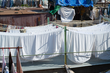 Dhobi Ghat, open air laundry in Mumbai, India, cleaned clothes hanging on clothes line to try, washing bedsheets and linenの写真素材